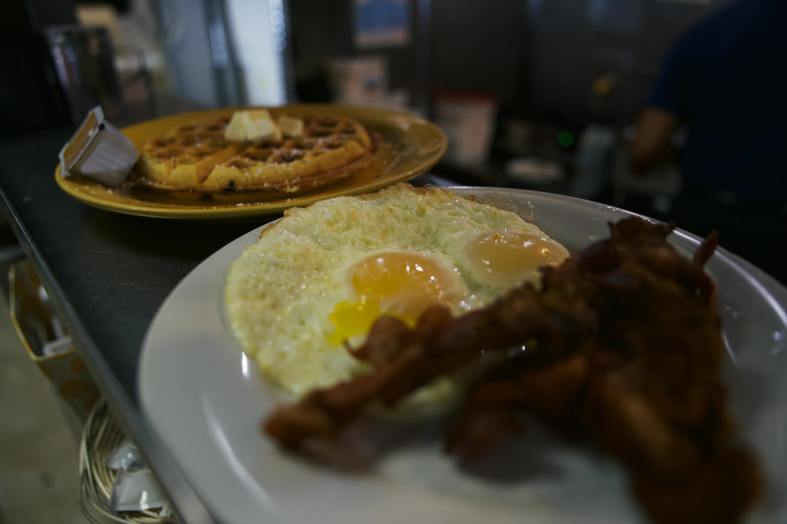 Breakfast plate with eggs, bacon and pancakes