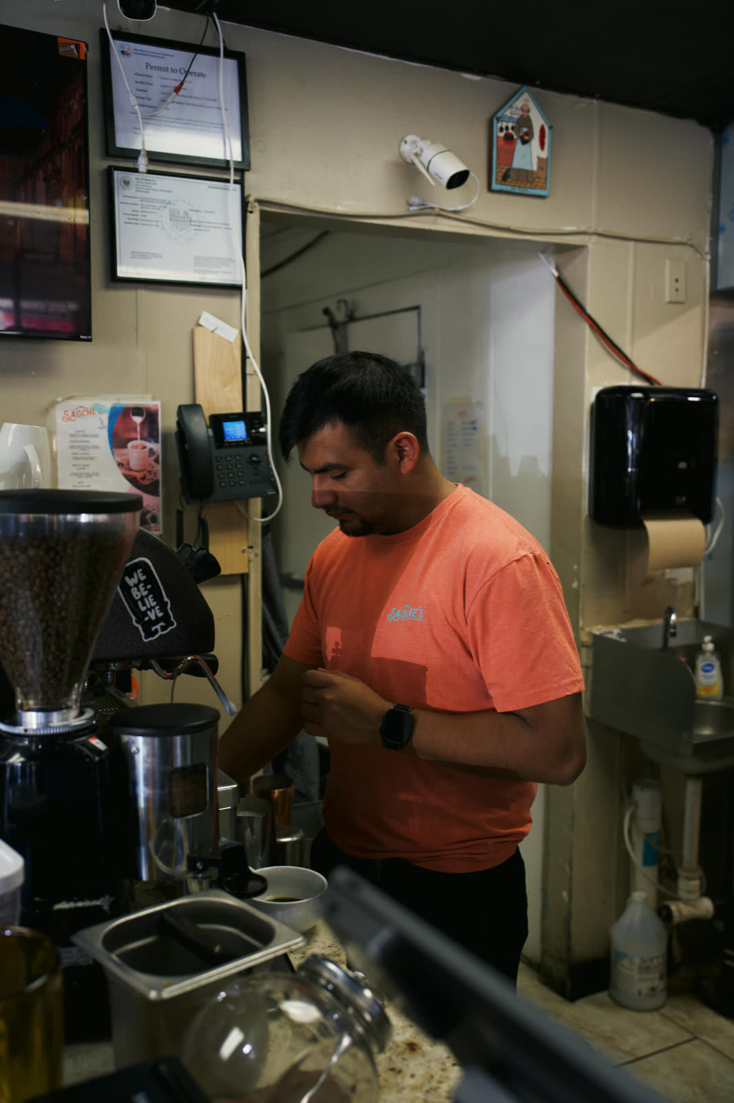 Barista preparing drinks behind the counter
