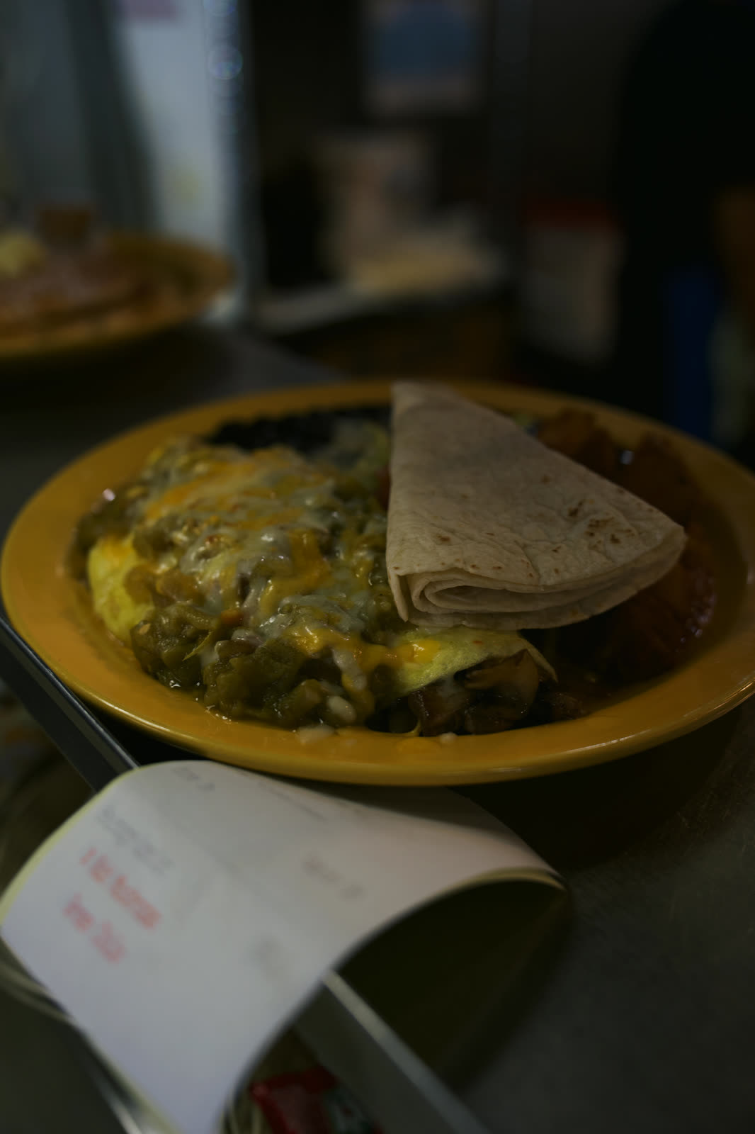 Smothered plate with melted cheese and a warm tortilla