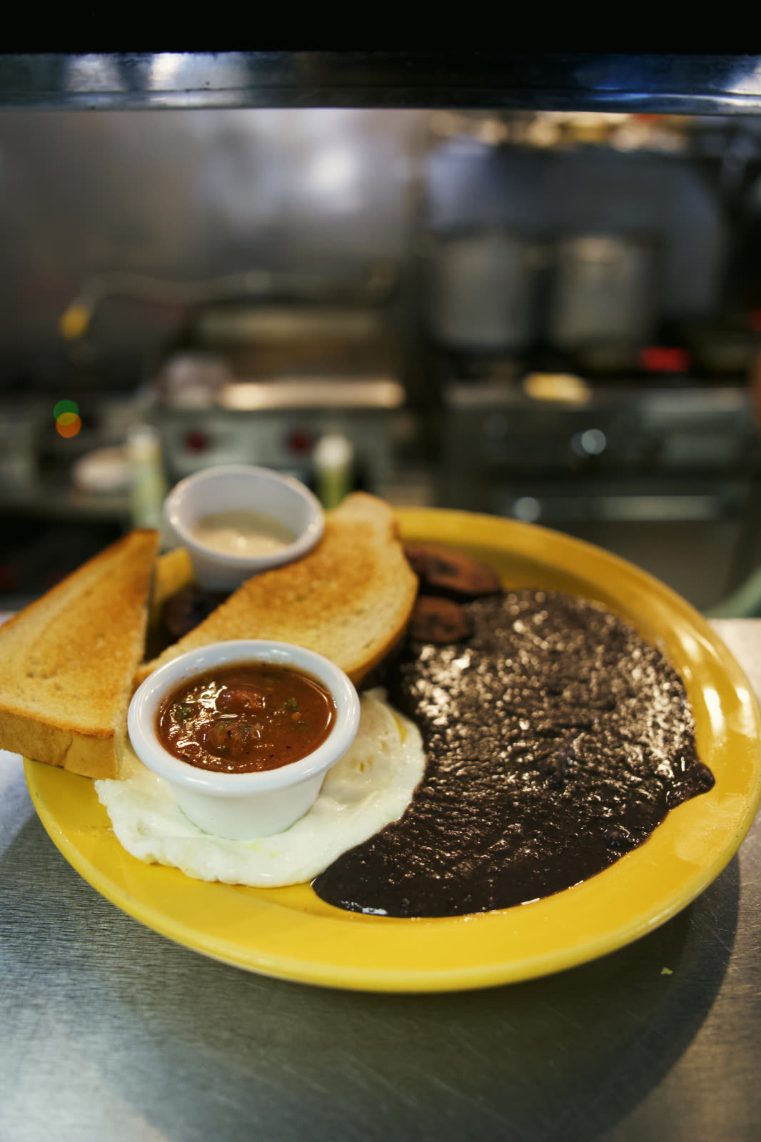 Traditional Guatemalan breakfast with black beans, fried plantains, eggs and salsa